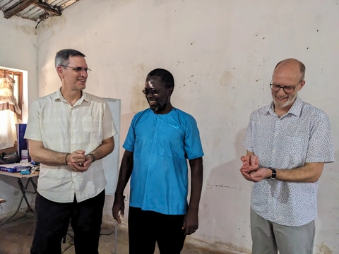 Eric and John are given rice, a symbol of blessing, by ITA director Miguel Indibé