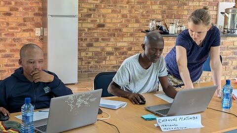 Emilee helping a student as he creates his first page