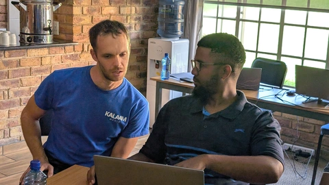 Roman helps a student with feedback on Day 5