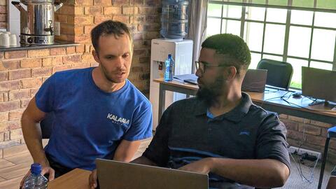 Roman helps a student with feedback on Day 5