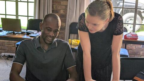 Emilee helps a student with feedback on Day 5