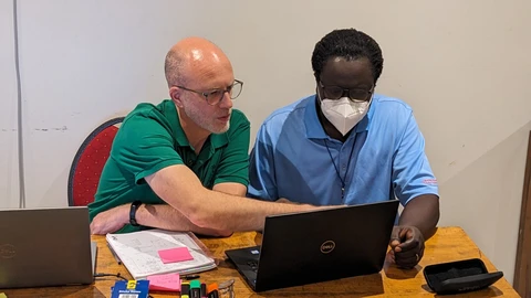 John supporting the Gambian Karon trainee 