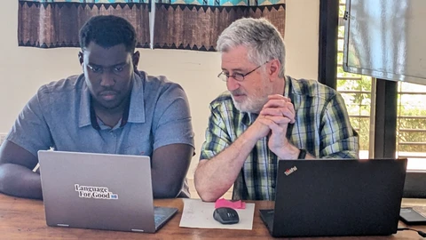 Dan working with SIL staff member Josué on a Senegal Bible site