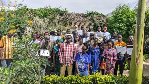 Group photo of guests & trainees (obscured by the plants!)
