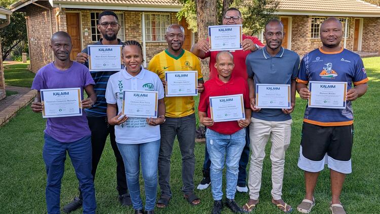 Website managers pose for a group photo with their certificates